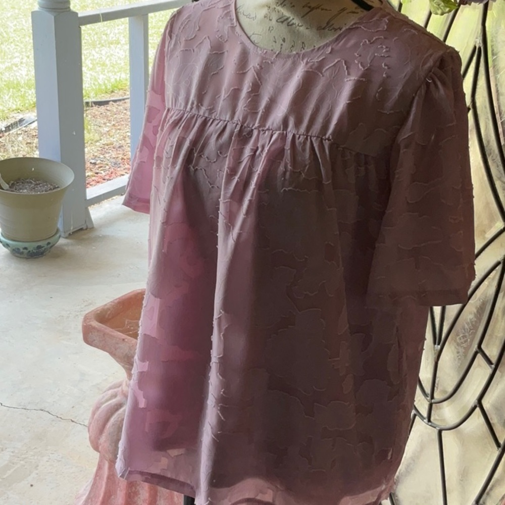 Mauve color top. Great top to dress up or wear out with shorts.  Fits loose.